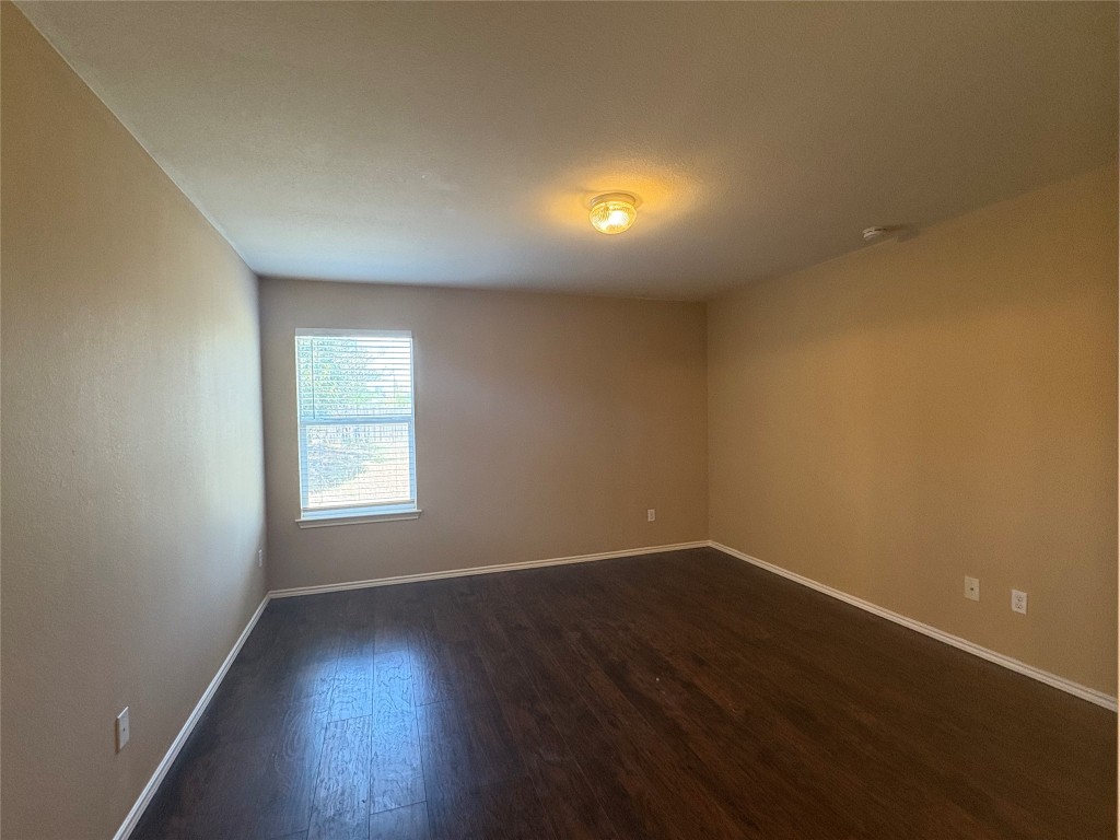 18316 Great Falls Drive Manor, TX 78653 - Photo 12 of 25 an empty room with wooden floor and windows