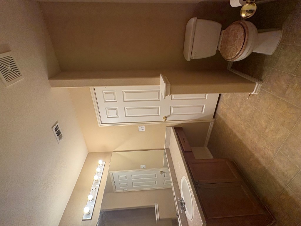 18316 Great Falls Drive Manor, TX 78653 - Photo 14 of 25 a bathroom with a toilet sink and mirror