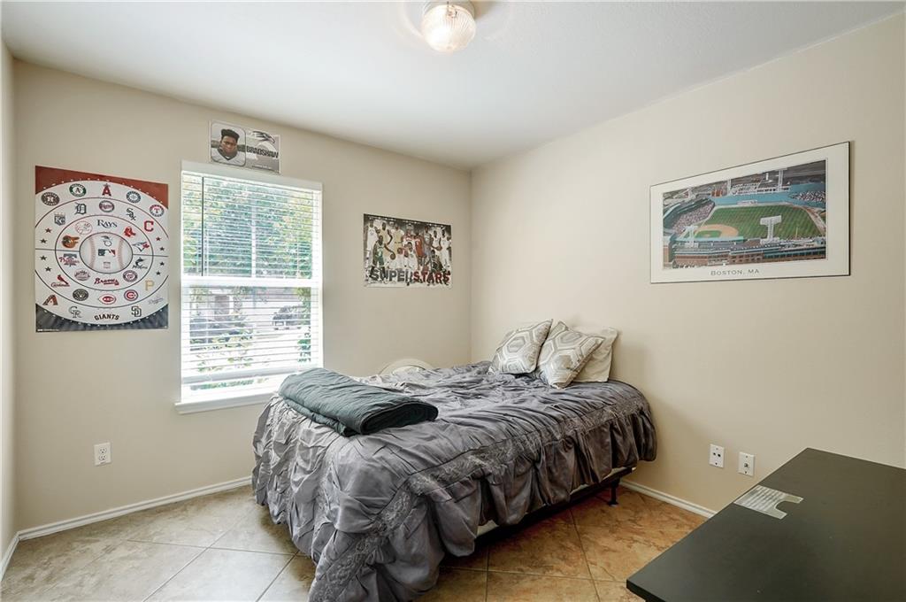 18316 Great Falls Drive Manor, TX 78653 - Photo 17 of 25 a bedroom with a bed and a window