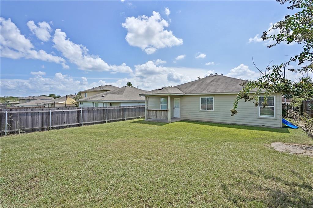 18316 Great Falls Drive Manor, TX 78653 - Photo 18 of 25 a view of a house with a yard and a garden