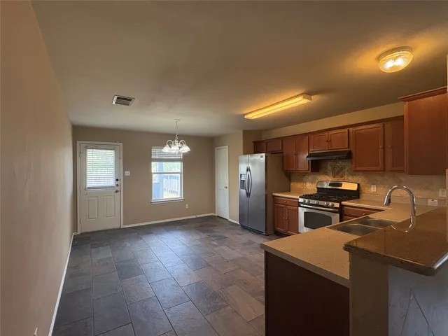a view of wooden floor and a window
