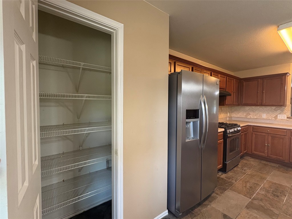 18316 Great Falls Drive Manor, TX 78653 - Photo 23 of 25 a kitchen with a refrigerator and cabinets