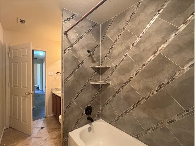 a bathroom with a toilet and shower
