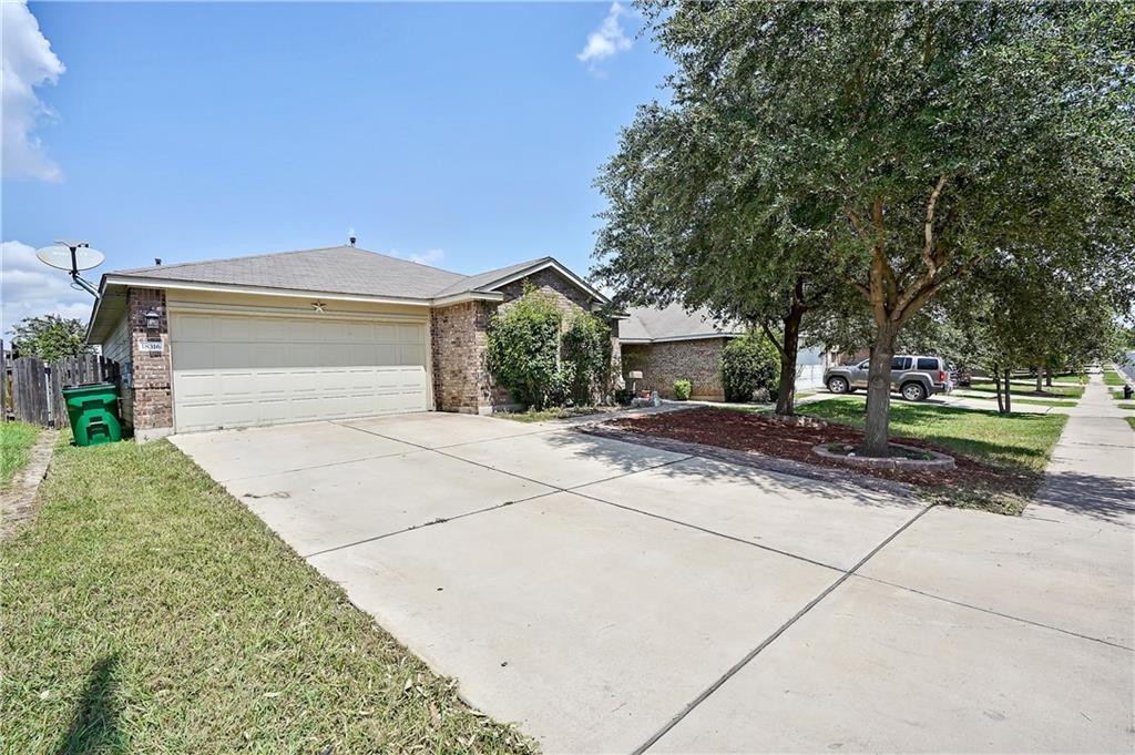 18316 Great Falls Drive Manor, TX 78653 - Photo 10 of 25 a front view of a house with a yard and garage