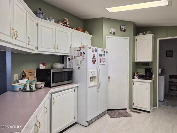 a kitchen with stainless steel appliances a refrigerator sink and cabinets