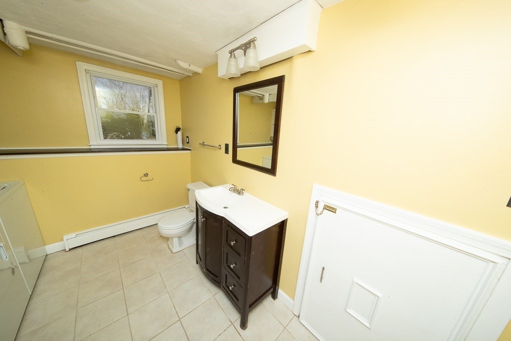 149 Salem Road Billerica, MA 01821 - Photo 20 of 21 a bathroom with a sink a mirror and a window
