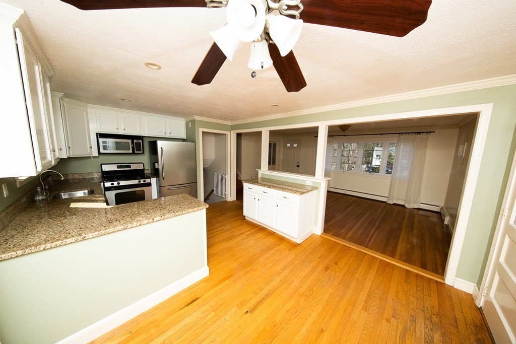 149 Salem Road Billerica, MA 01821 - Photo 8 of 21 a large kitchen with stainless steel appliances granite countertop a refrigerator and a stove