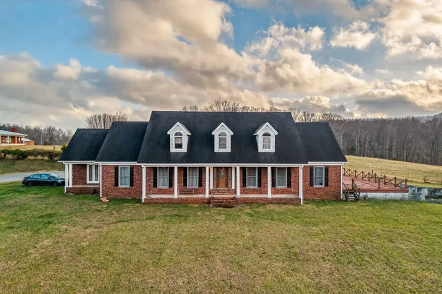 a view of a house with a garden and yard