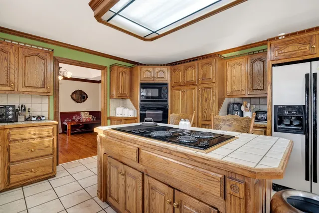 a dining room with furniture a chandelier and wooden floor