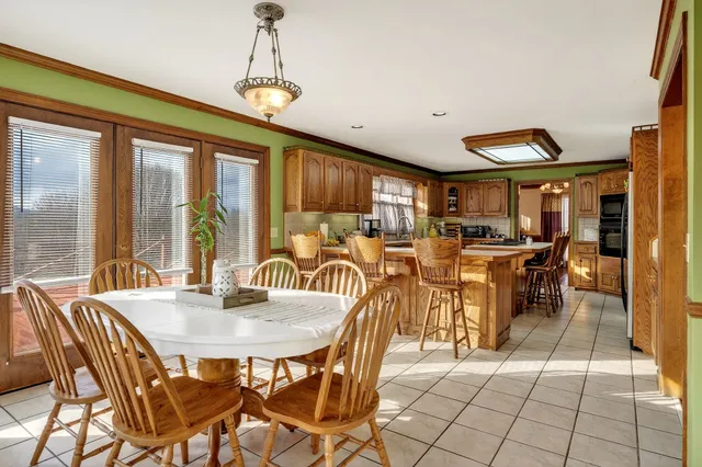 a dinning table and chairs in a kitchen