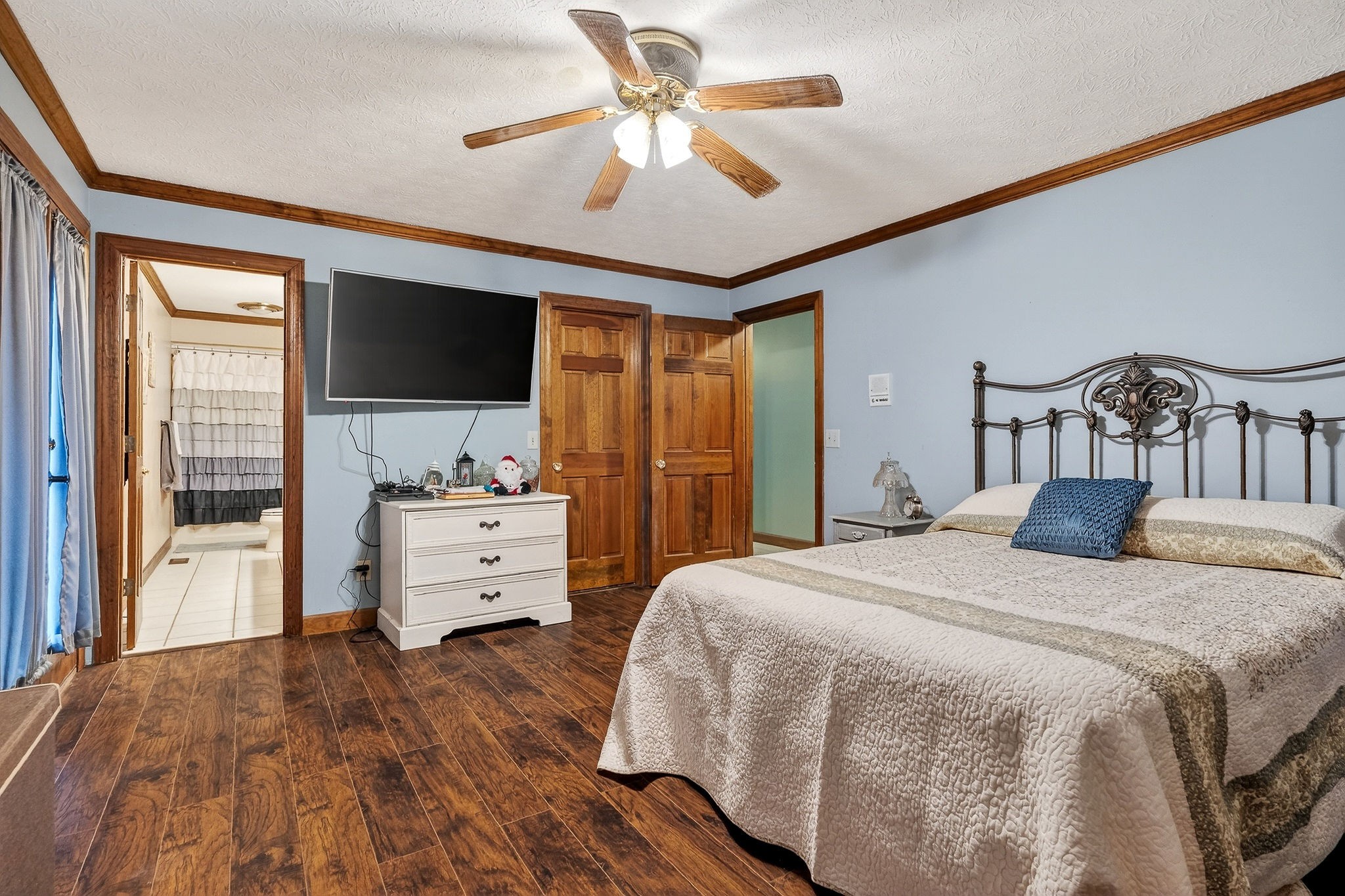 9334 Short Mountain Road Smithville, TN 37166 - Photo 18 of 51 a spacious bedroom with a bed and a flat screen tv