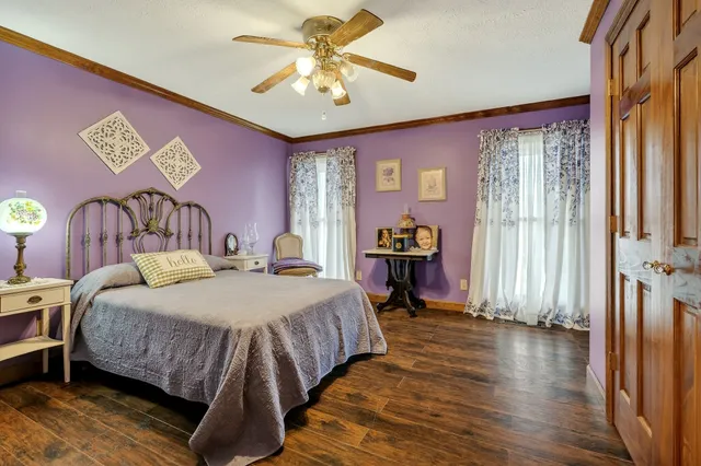 a bedroom with a bed a dresser and chair