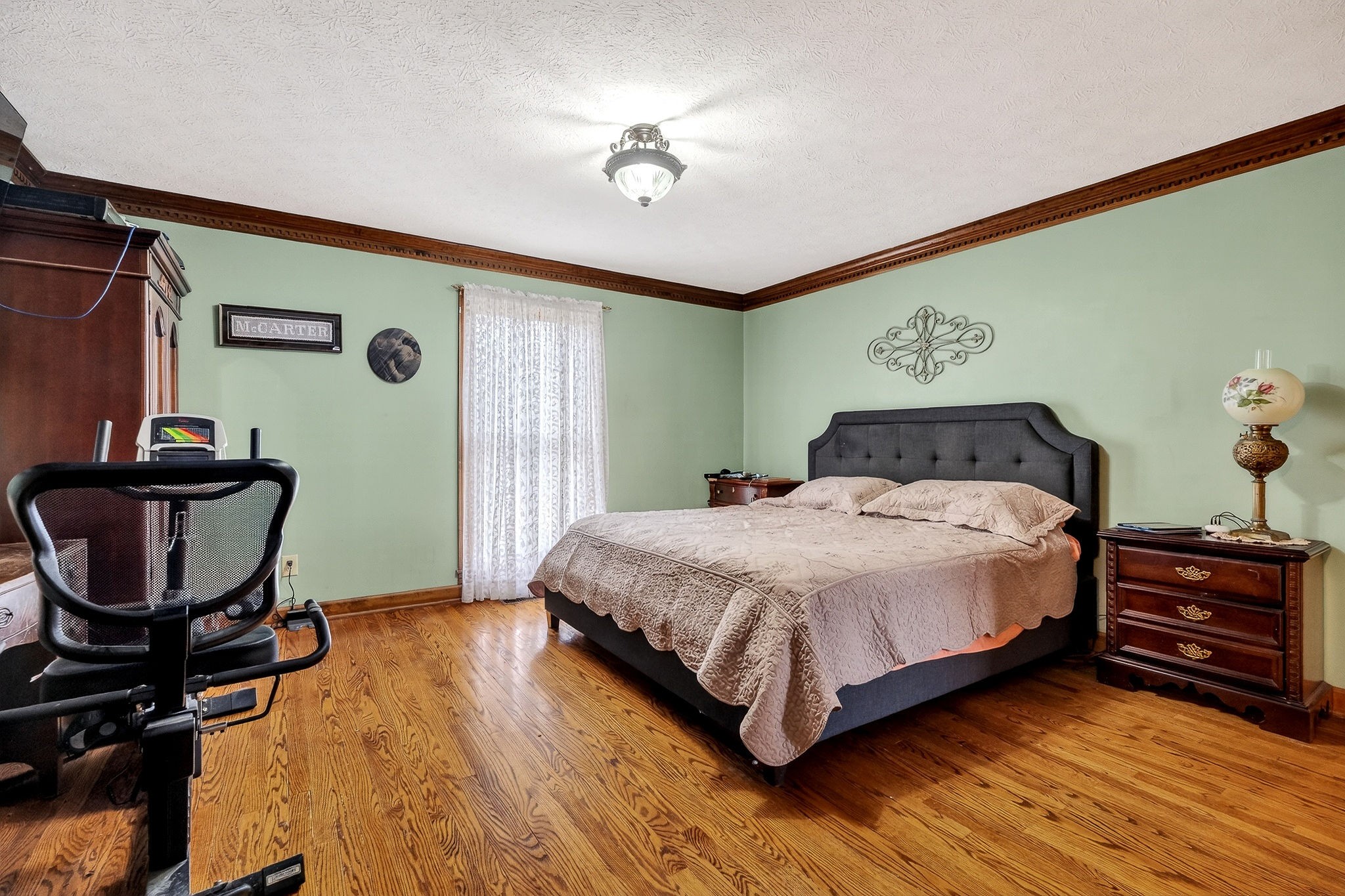 9334 Short Mountain Road Smithville, TN 37166 - Photo 22 of 51 a bedroom with a bed a dresser and chair