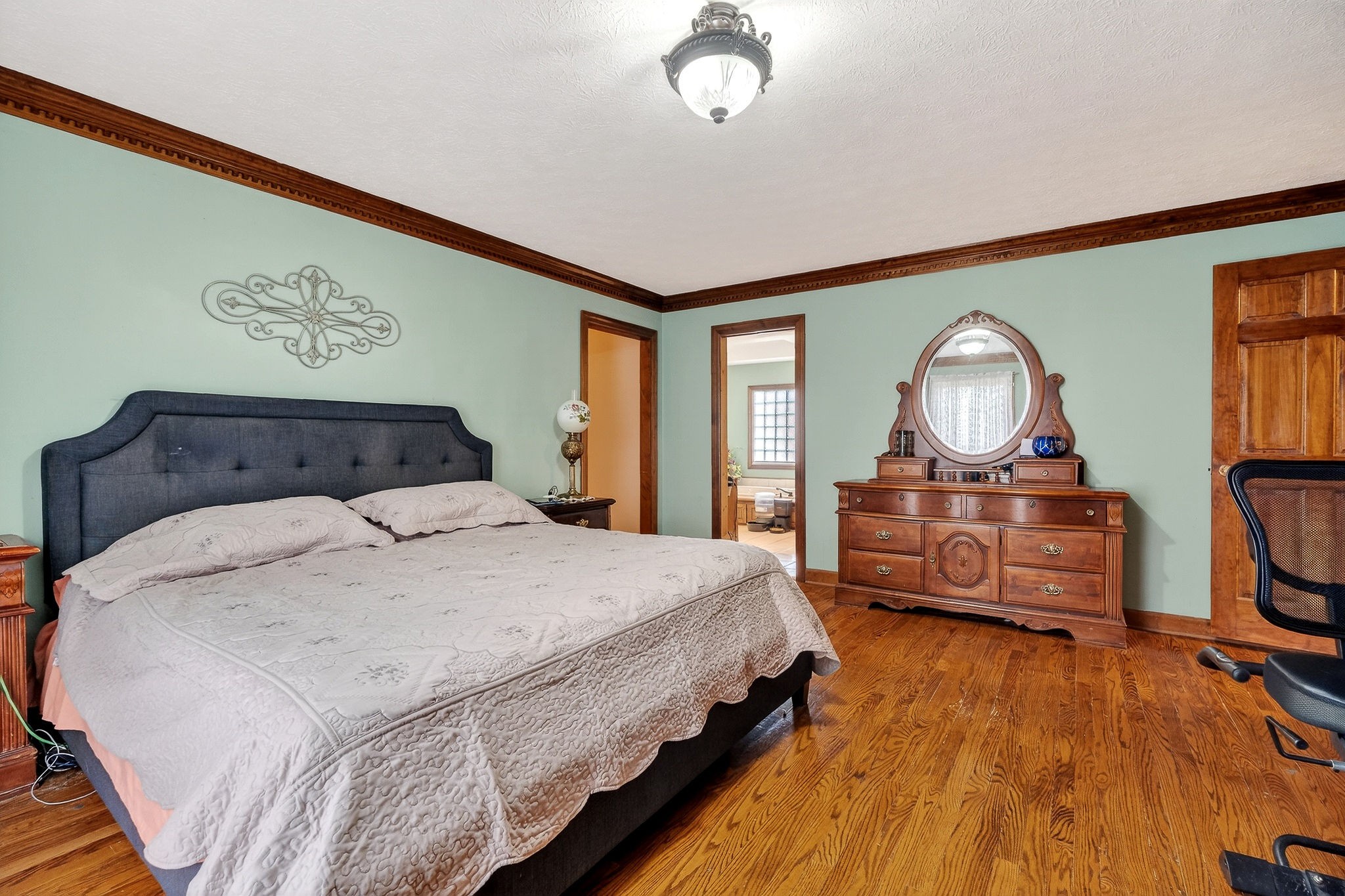 9334 Short Mountain Road Smithville, TN 37166 - Photo 23 of 51 a bedroom with bed and wooden floor