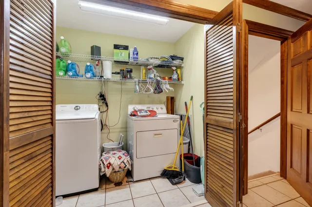 a spacious bedroom with a bed and a flat screen tv