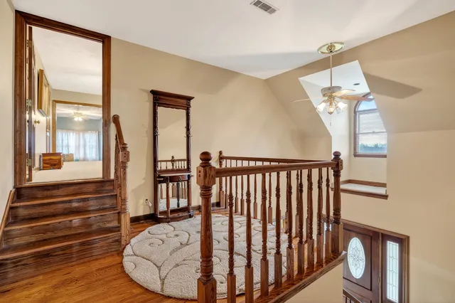 a spacious bedroom with a bed a couch and dresser