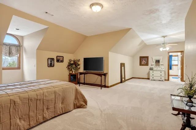 a large bathroom with a double vanity sink a mirror and a bathtub