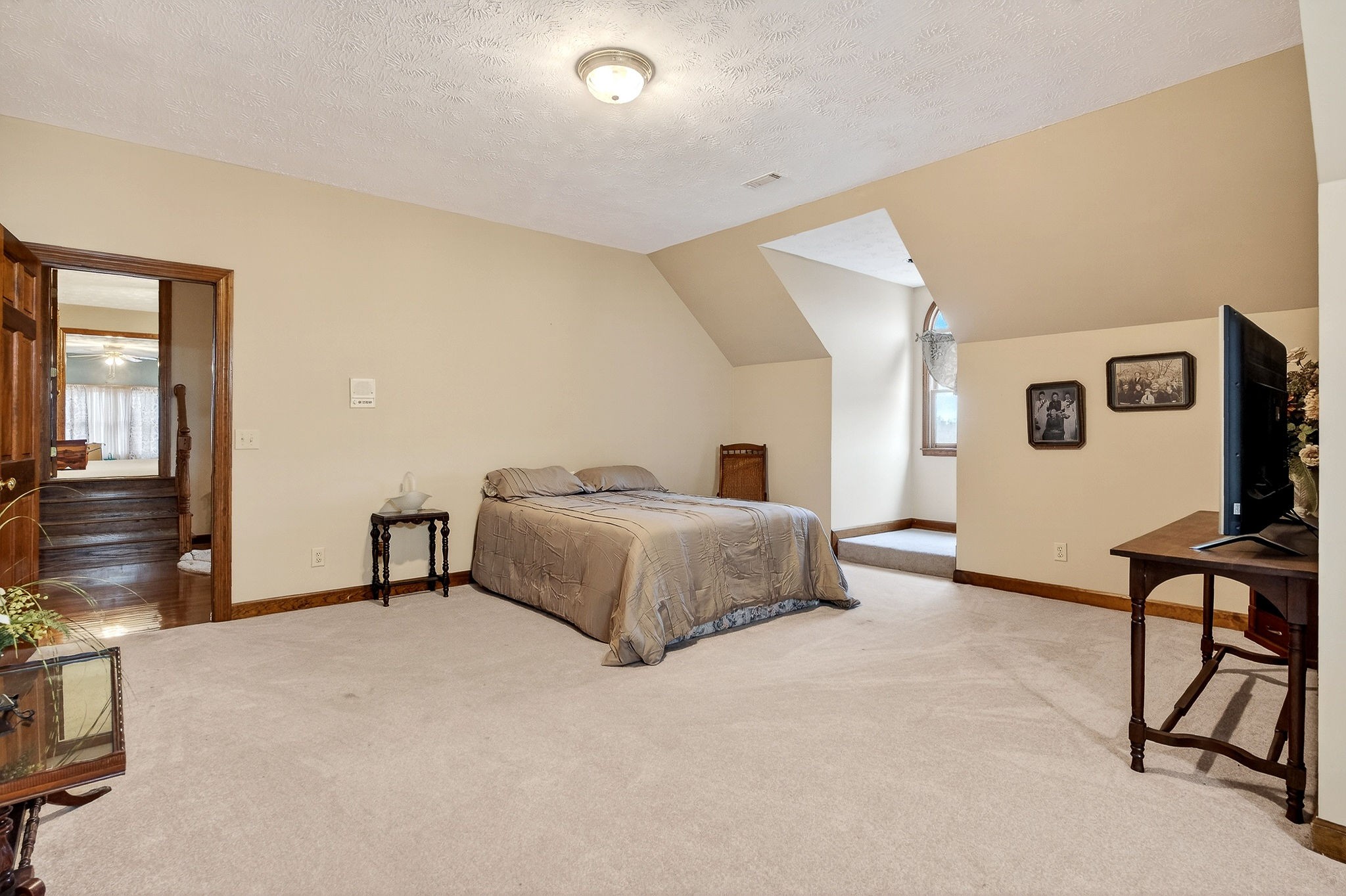 9334 Short Mountain Road Smithville, TN 37166 - Photo 30 of 51 a spacious bedroom with a bed a couch and dresser