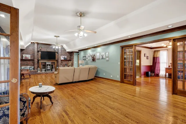 a view of a livingroom with furniture a flat screen tv and front door