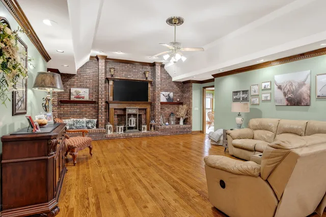 a living room with fireplace furniture and a flat screen tv