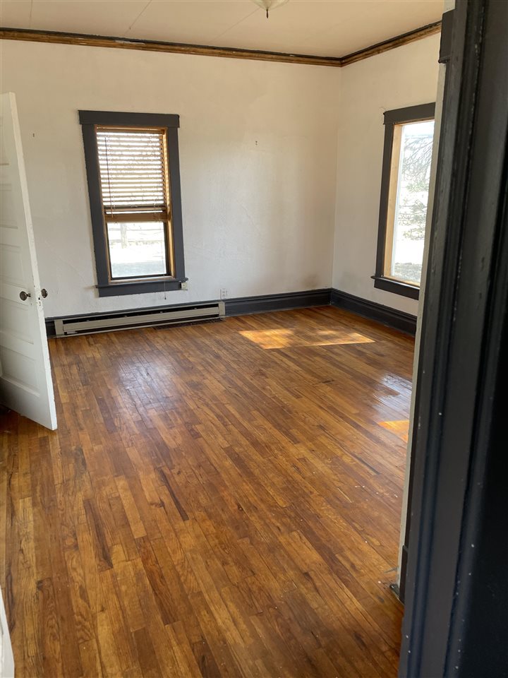 2373 I Road Grand Junction, CO 81505 - Photo 18 of 20 an empty room with wooden floor and windows
