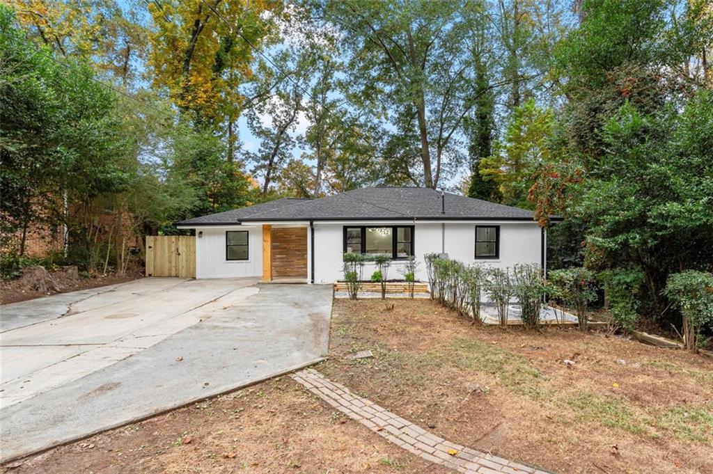 2875 Monterey Drive Decatur, GA 30032 - Photo 1 of 1 a front view of a house with a yard and trees