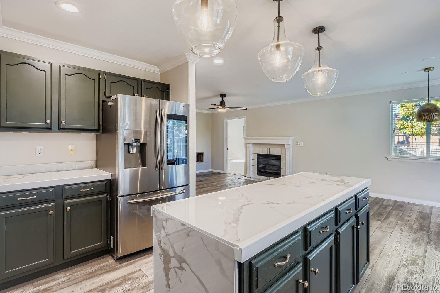 19827 East Prentice Avenue Centennial, CO 80015 - Photo 11 of 31 a kitchen with a refrigerator a sink and wooden floor