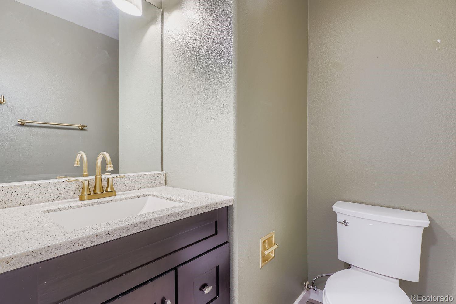 19827 East Prentice Avenue Centennial, CO 80015 - Photo 14 of 31 a bathroom with a sink a toilet and mirror
