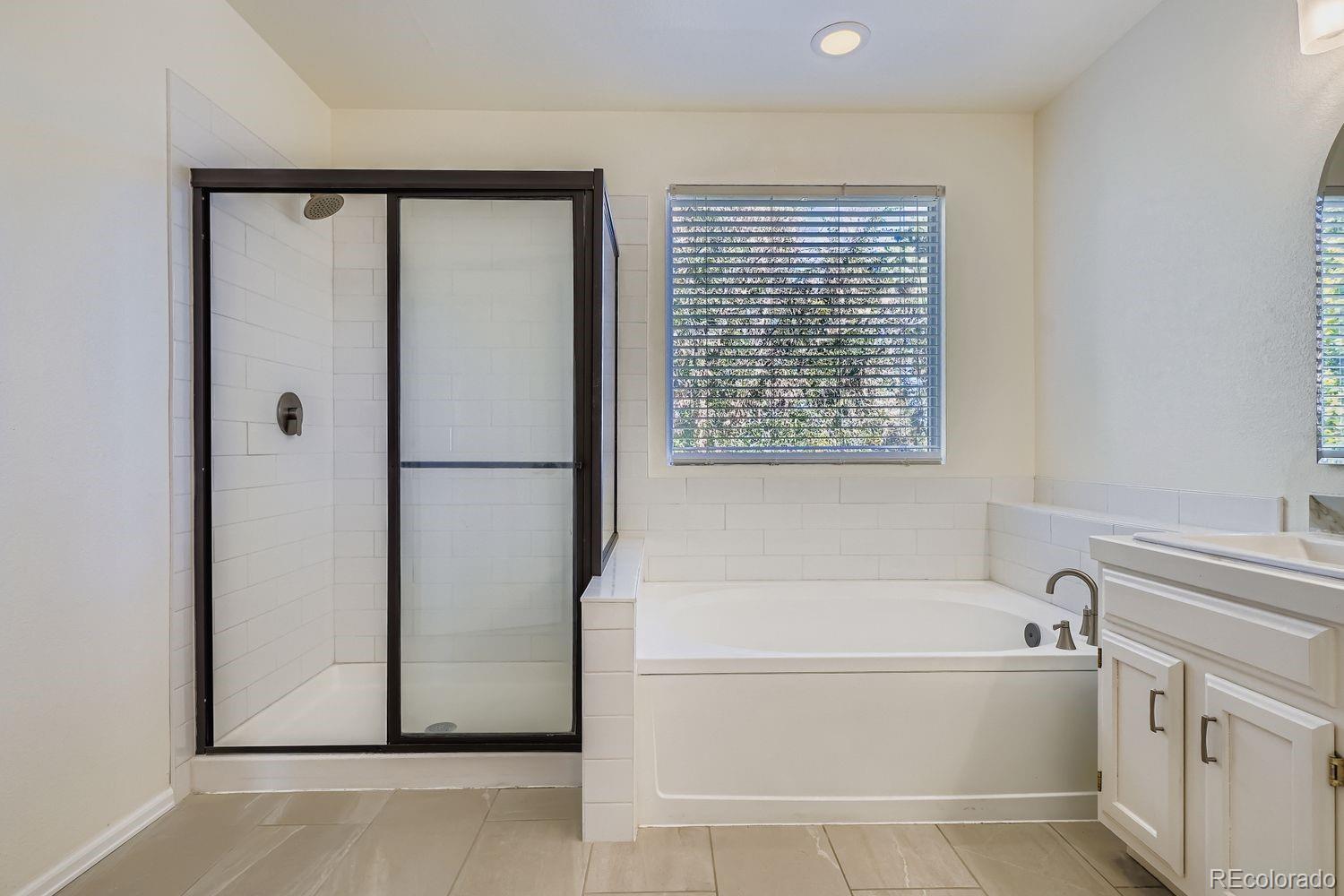 19827 East Prentice Avenue Centennial, CO 80015 - Photo 20 of 31 a spacious bathroom with a bathtub and a shower