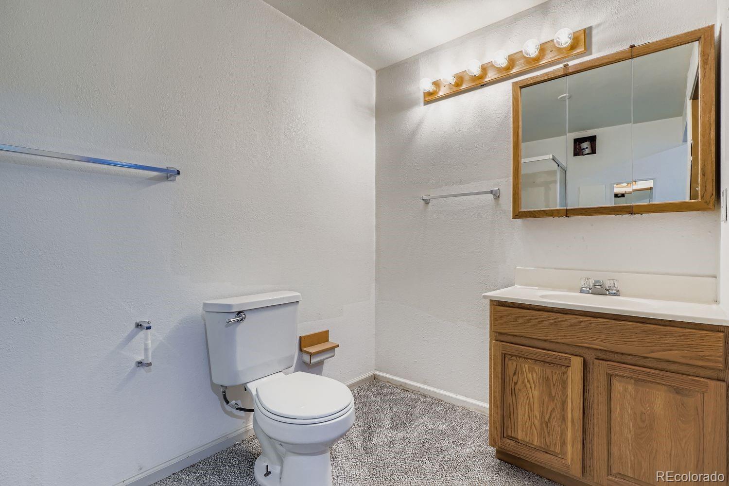 19827 East Prentice Avenue Centennial, CO 80015 - Photo 25 of 31 a bathroom with a toilet sink and mirror