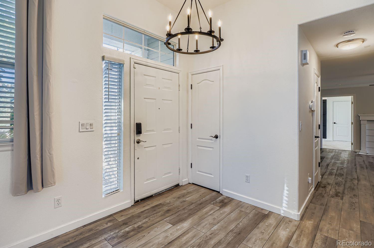19827 East Prentice Avenue Centennial, CO 80015 - Photo 4 of 31 a view of a hallway with wooden floor and closet area