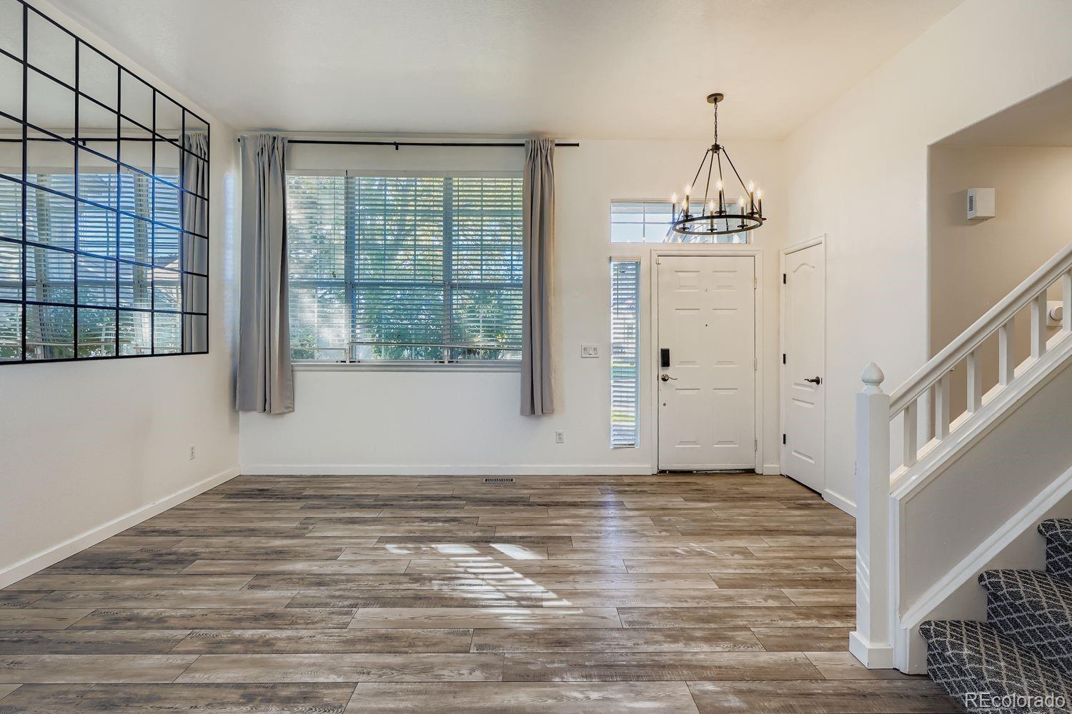 19827 East Prentice Avenue Centennial, CO 80015 - Photo 6 of 31 a view of empty room with wooden floor and fan