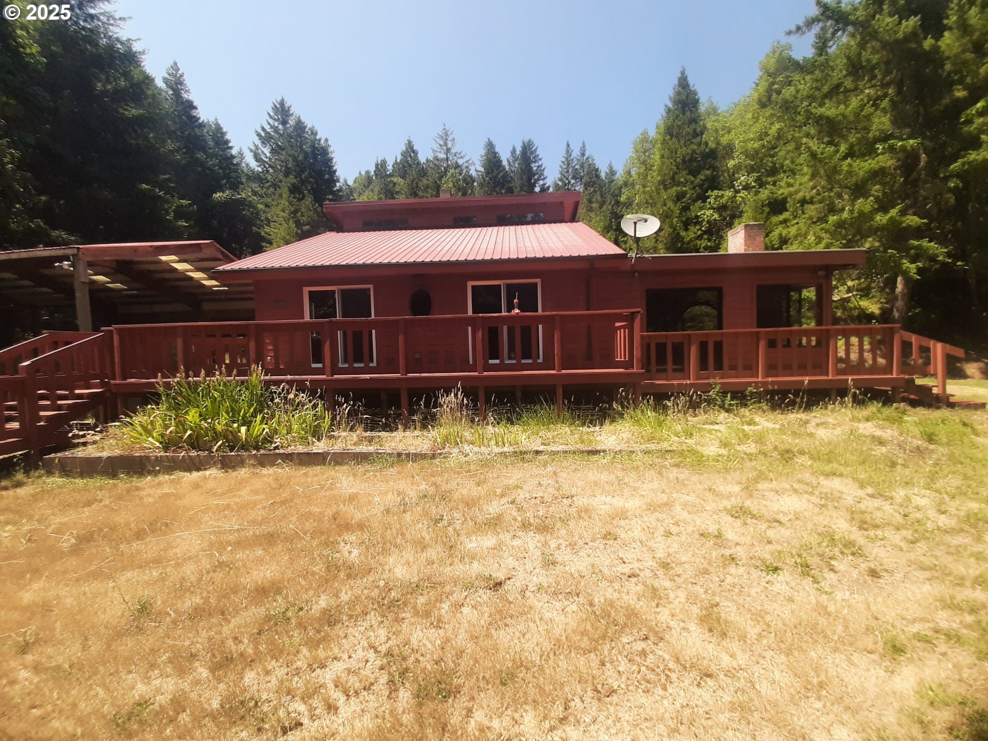 252 May Creek Road Days Creek, OR 97429 - Photo 13 of 35 a view of a house with a yard and large tree