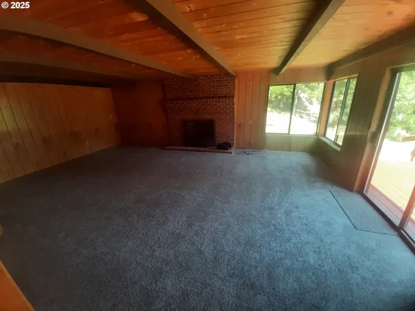 a view of empty room with fireplace