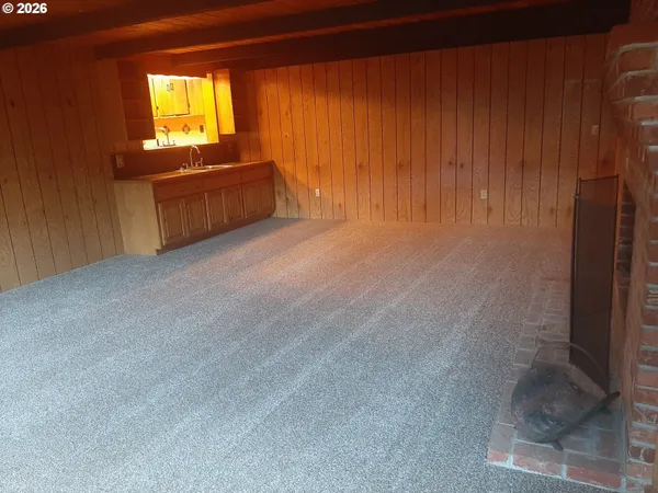 an empty room with wooden floor and sliding door