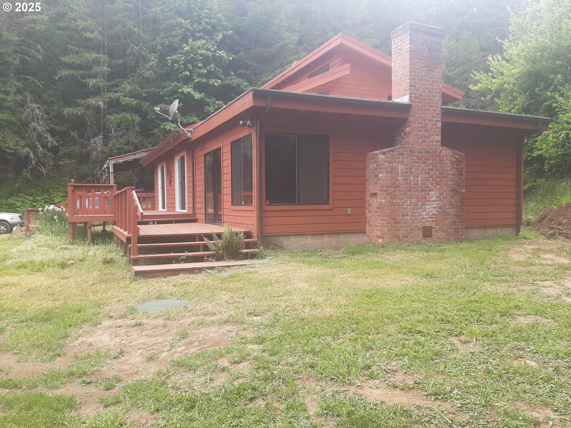 252 May Creek Road Days Creek, OR 97429 - Photo 6 of 35 a front view of a house with garden