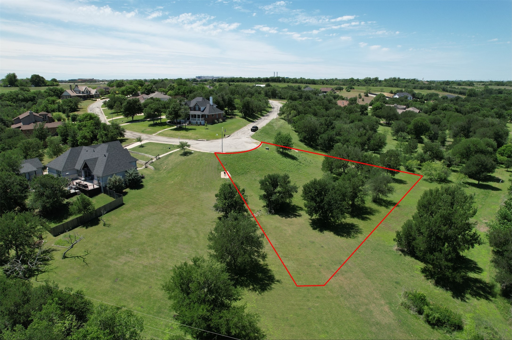 1700 Tanner Loop Taylor, TX 76574 - Photo 5 of 32 Spacious residential lot featuring mature trees and a gentle slope
