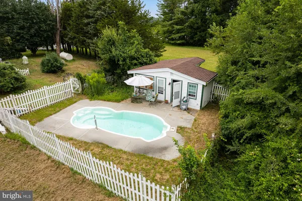 a view of a house with swimming pool and sitting area