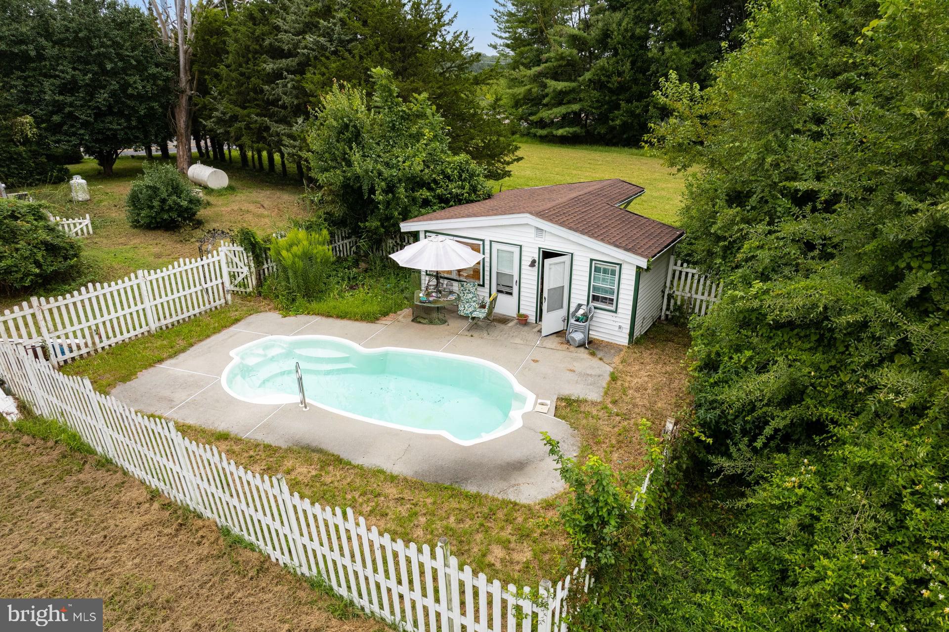 179 Alloway Creek Neck Road Salem, NJ 08079 - Photo 5 of 9 a view of a house with swimming pool and sitting area