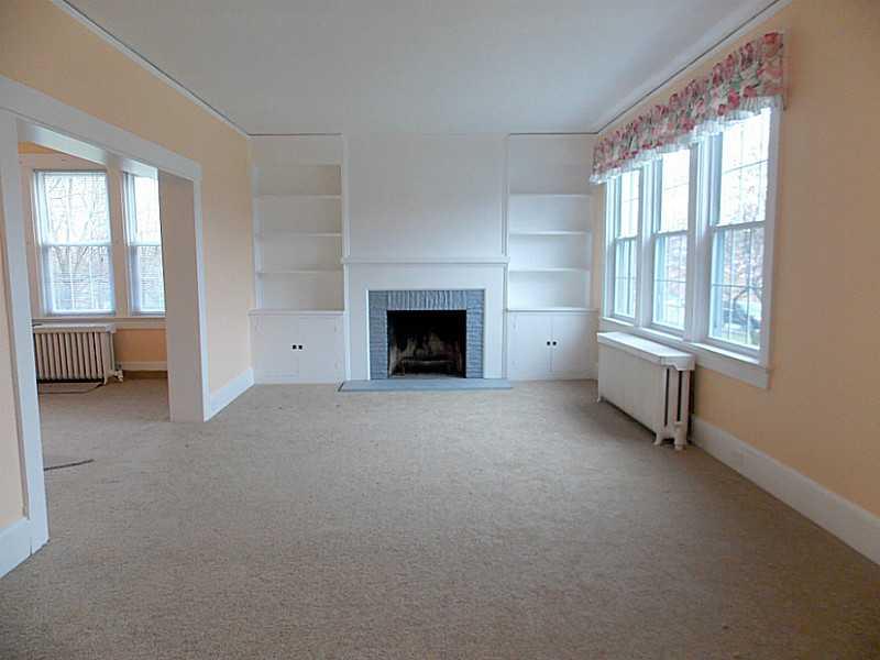 601 West Ingomar Road Pittsburgh, PA 15237 - Photo 5 of 25 Living Room. LIVING ROOM WITH WOOD BURNING FIREPLACE AND BUILT IN SHELVING