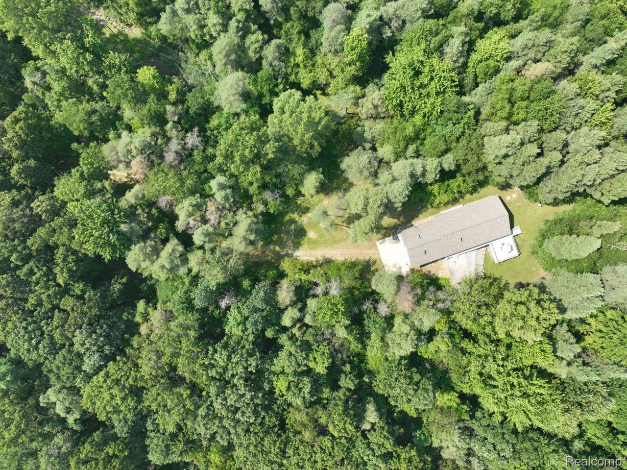 10201 Washburn Road Goodrich, MI 48438 - Photo 78 of 85 Single-story residence surrounded by dense, mature tree canopy