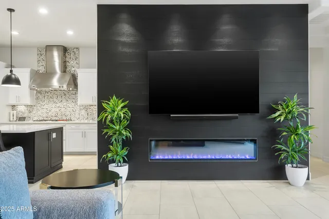 a living room with a potted plant and a fireplace