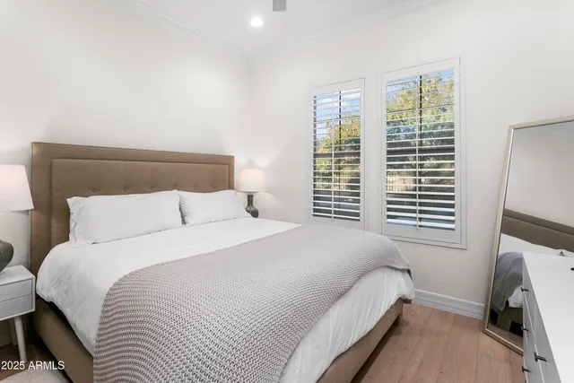 a bedroom with a bed a fireplace and a large window