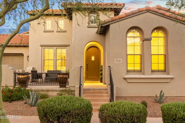 a front view of a house with a garden