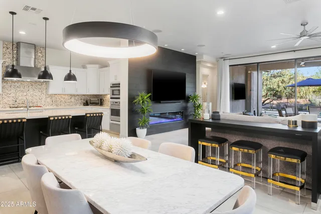 a kitchen with a stove a sink a dining table and chairs