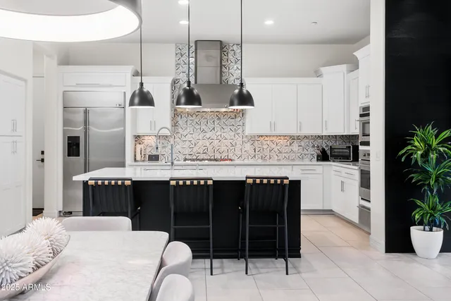a kitchen with a refrigerator and stove