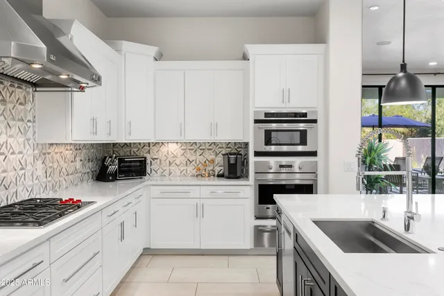 a kitchen with a sink stove top oven and cabinets
