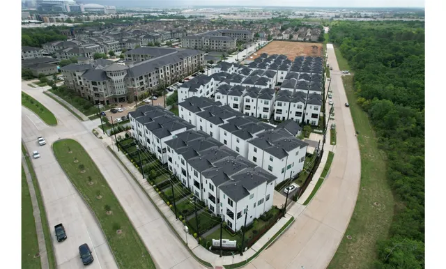 an aerial view of a residential apartment building with a yard