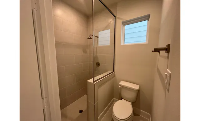 a white toilet sitting next to a bathroom sink