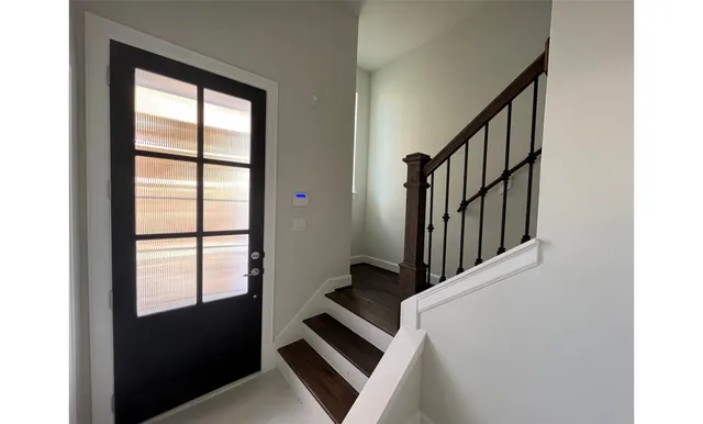 a view of an entryway with wooden floor